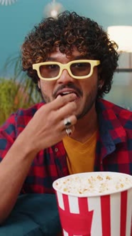 Enthusiastic Man Watching Movie with Popcorn and 3D Glasses