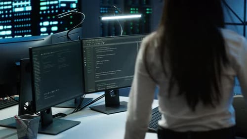 Engineer in Data Center Sitting Down at Desk Installing Software