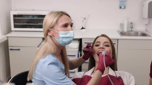 Dentist Working on Patient's Teeth in Office