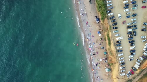Aerial View of Sandy Beach Swimming People in Sea Bay with Transparent Blue Water at Sunset in
