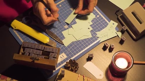 Creative Hands Crafting Christmas Gift Tags at Table