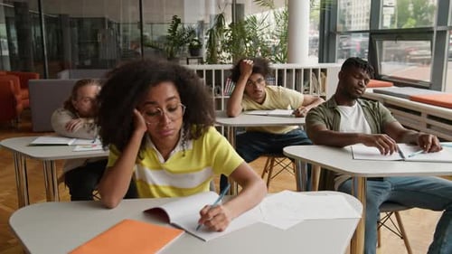 Group of Boring Sad Tired Multiethnic University Students Listening Boredom Lecture in Classroom