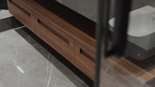 Modern bathroom interior featuring sleek wood cabinet drawers