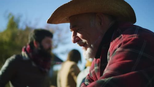 Smiling Man in Cowboy Hat and Plaid Shirt