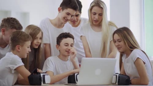 Group of Friends Using Laptop and VR Headsets