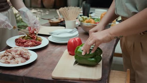 Unrecognizable Friends Preparing Meat and Vegetable for Grill