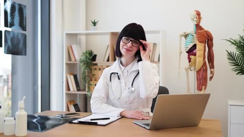 Confident Female Doctor at Office Desk Ready to Assist Patients