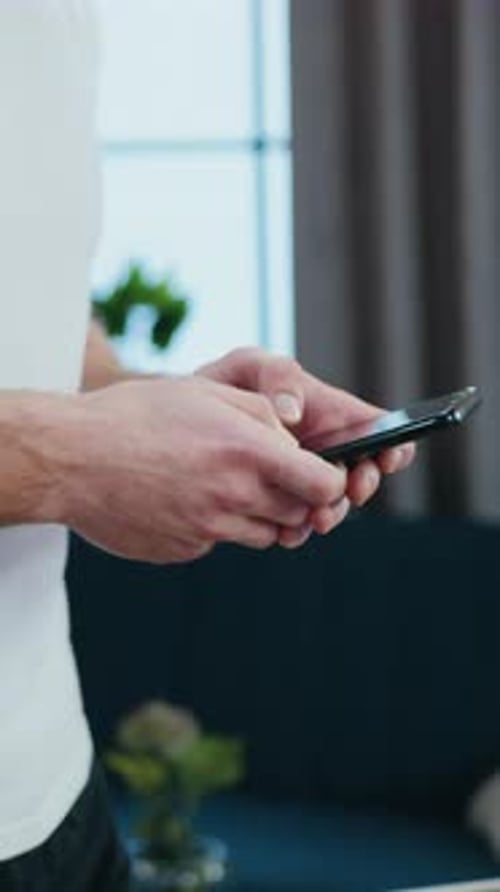Man Using Cellphone Indoors During Fitness Treadmill Workout