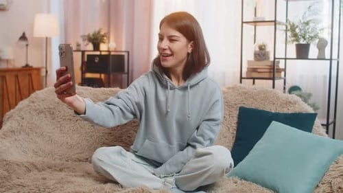 Woman Video Chatting Comfortably in Her Home