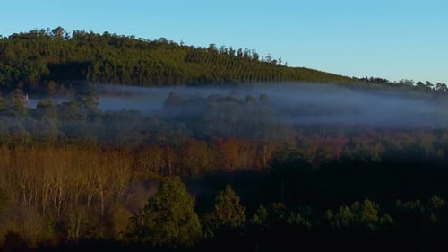 Low Misty Clouds Over Forest Mountains At Sunrise In Paiosaco, A Laracha, A Coruña Spain. Aerial Sho