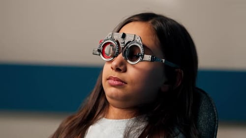In an Ophthalmology Clinic Obese Doctor Tries on Provisional Glasses for a Girl to Choose Lenses