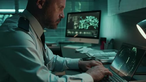 Satellite System Operator Working on Laptop at Military Command Center