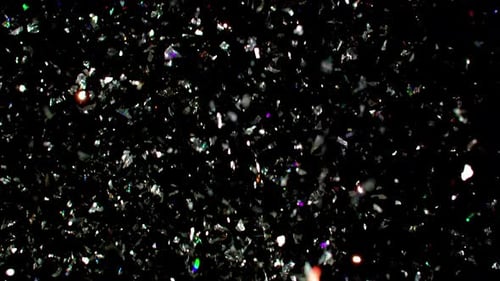 Dazzling Silver Confetti Falling on Black Background