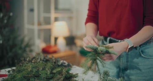 Woman Preparing Christmas Wreath Garland For Christmas Holidays