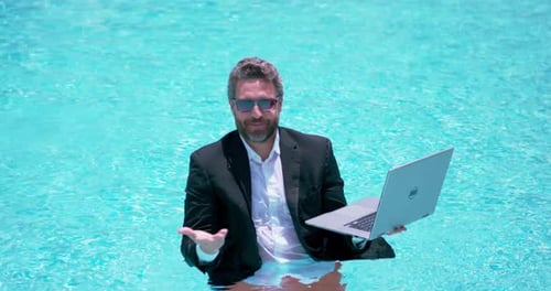 Business Man in Suit Working on Laptop in Swimming Pool Travel Tourism and Business Concept Crazy