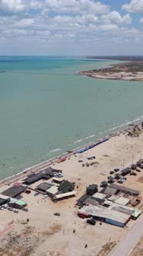 Aerial Vertical Video of Manaure Beach, La Guajira, Colombia - Lively Coastal Scene