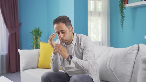 Man looking depressed at camera.