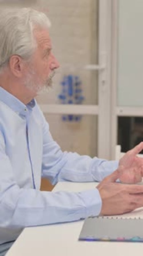 Side view of Old Man Talking with Employees, vertical video