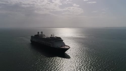 Cruise Ship Sails on Open Ocean Under Cloudy Sky