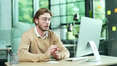 Sick unhealthy business man office worker suffers from allergies sneezes with a runny nose while