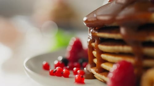 Delicious Pancakes with Chocolate Sauce and Berries