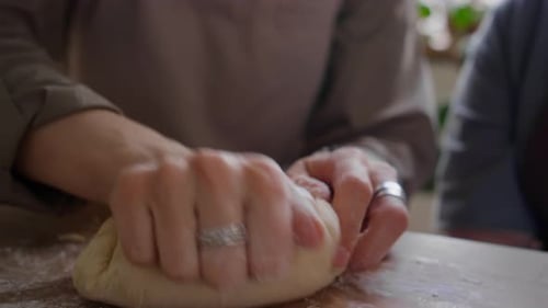 Close-Up of Kneading Dough at Kitchen Table