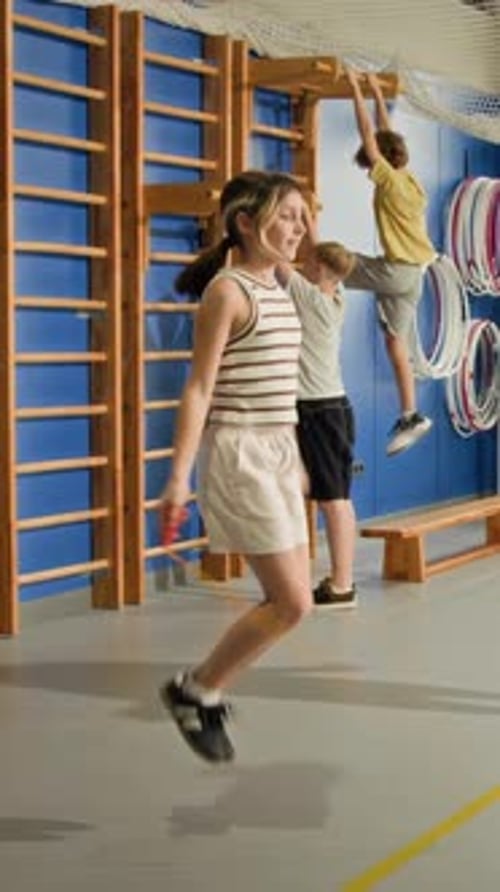Gir Doing Jumping Rope Exercises in Indoor Gym Vertical