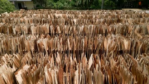 Drone Flying Over an Outdoor Wood Plank Warehouse Next to the Road in Vietnam