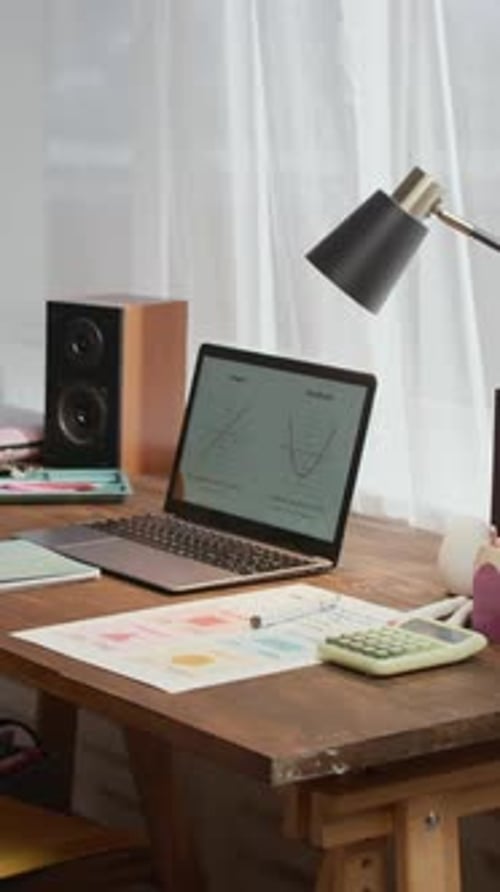 Working Laptop with Function Graphs on Screen