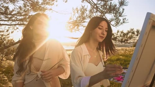 Two Friends are Talking About Their Paintings They are Making Them in a Beautiful Summer Landscape