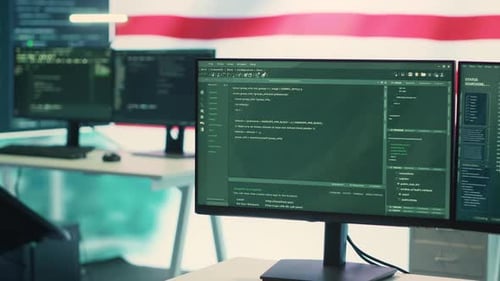 Computer Monitors displaying Code in an Office