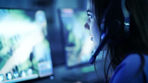 Female Gamer Playing Video Game Wearing Headset