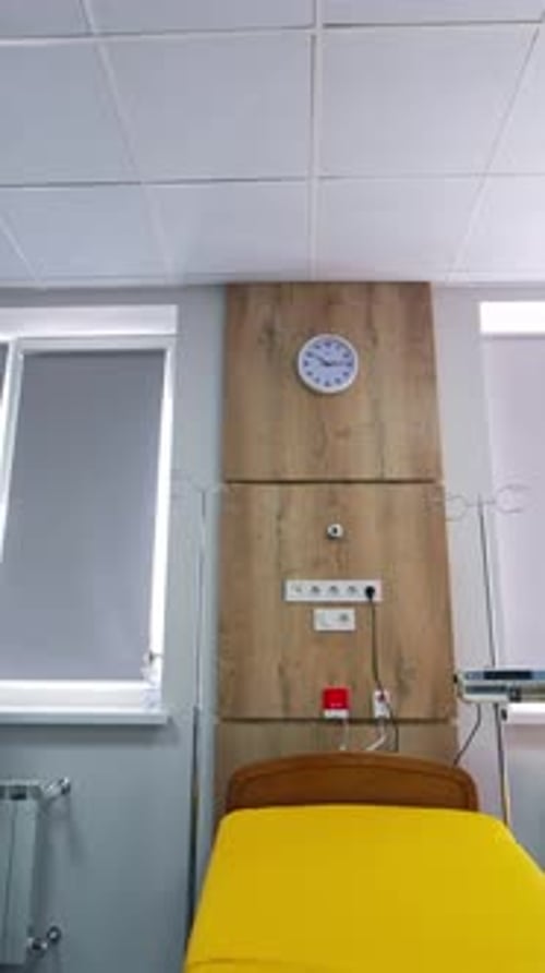 Empty wheeled bed for women in labor. Big light delivery ward in up-to-date maternity clinic