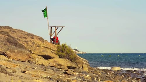 Lifeguard Station with Green Flag on Coast