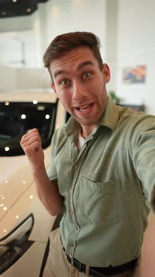 Vertical Selfie POV of Cheerful Handsome Male Blogger Streaming Online From Car Dealership Choosing