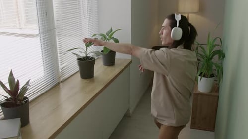 Relaxed Man in Headphones Dancing Freely at Home