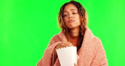 Sad woman, cinema popcorn and green screen eating movie snack and watching tv