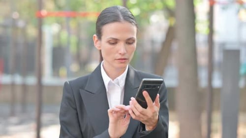 Young Woman Using Phone in Urban Environment