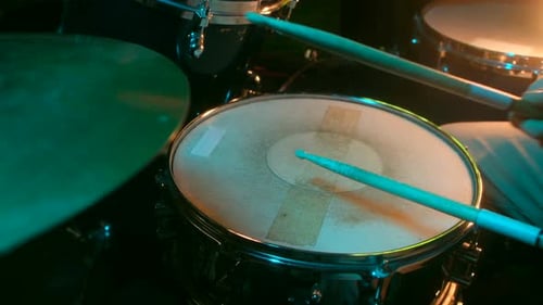 Man Plays with Sticks on a Snare Drum