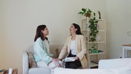Women Talking During Therapy Session in Bright Room
