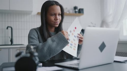 Woman Video Conferencing at Home on Laptop