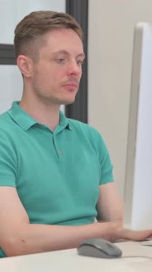 Man Works At Computer In Office