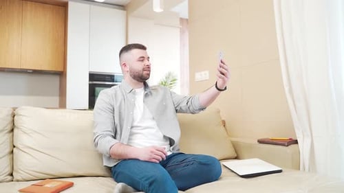 Man on Couch Talking on Video Call