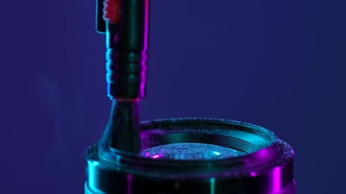 Cleaning Camera Lens with Brush Under Neon Light