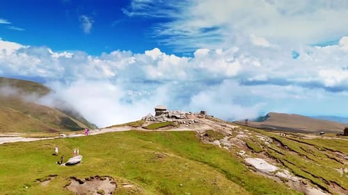 Mountain ridge shrouded in drifting clouds.