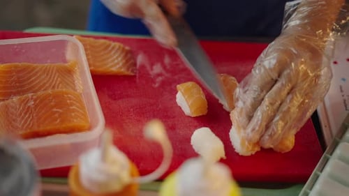 Unknown Man Slicing Salmon Fish for Nigiri Sushi at Local Thai Market
