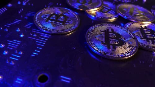 Bitcoin cryptocurrency on electronic circuit boards with blue light effect