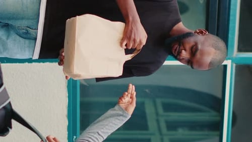 Vertical Video African American Courier Delivering Restaurant Meal to Wrong Client