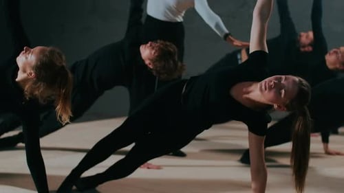 Side View Group of Theater Actors and Actresses in Plank Position Raising Hand Looking Up As Stage