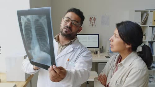 Medical Professionals Analyzing X-Ray in Bright Office